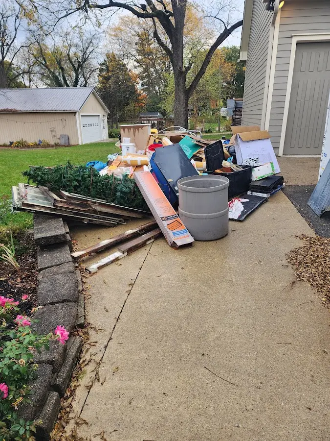 Dumpster being loaded with debris for 12 Yard Dumpster Rental in Greeneville